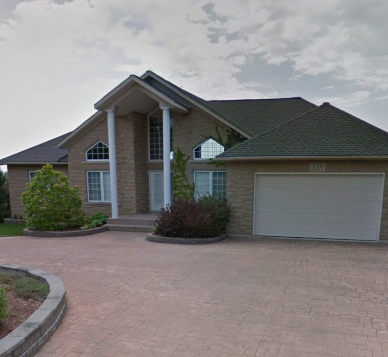 Kitchener home before exterior renovation. Tan brick and white trim.