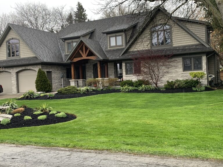Cambridge home after second storey addtion and exterior facelift. Natural timber entryway with tan brick and new siding.