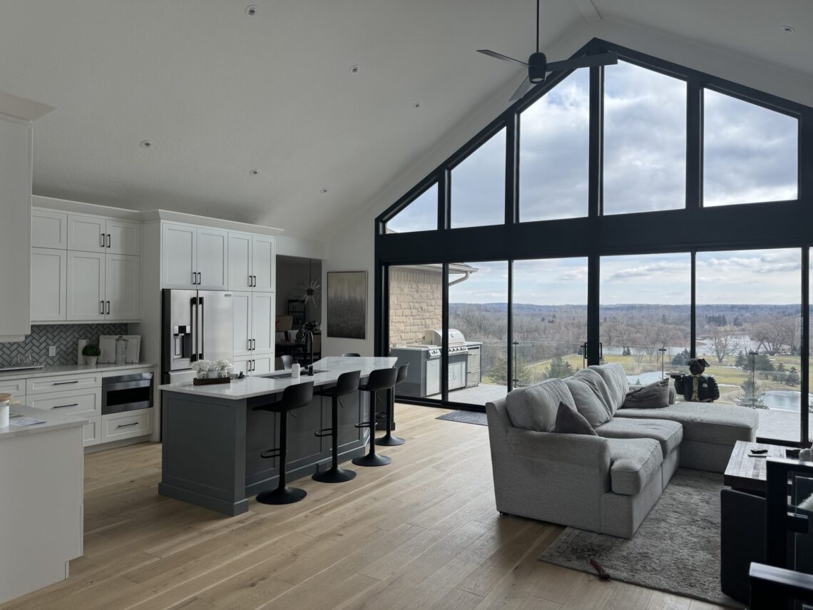 Open-concept kitchen and great room with vaulted ceiling and full-height windows, built by BRICON in Kitchener-Waterloo Region.