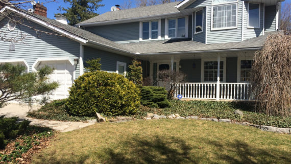 Kitchener home before exterior renovation. Blue siding with white trim.