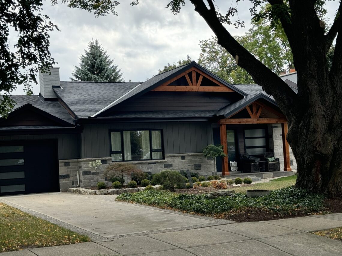 Waterloo home after external facelift. Natural stone and wood elements with black trim.