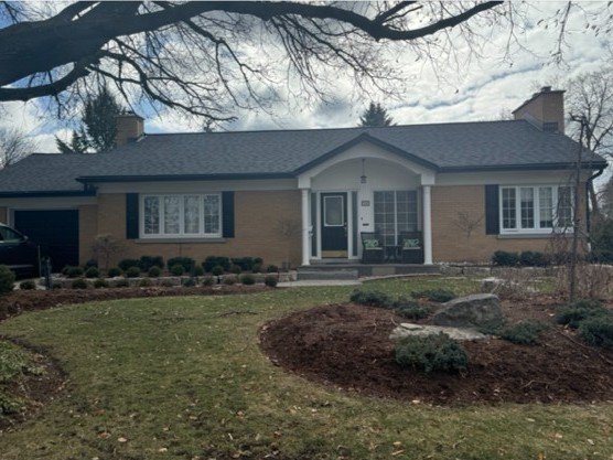 Waterloo home before exterior facelift. Tan brick and white trim.